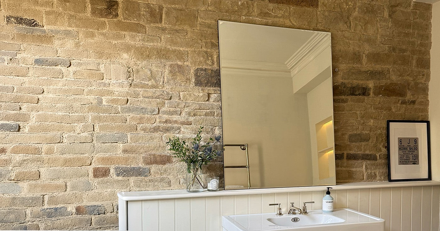 Irregular wall mirror in a bathroom setting