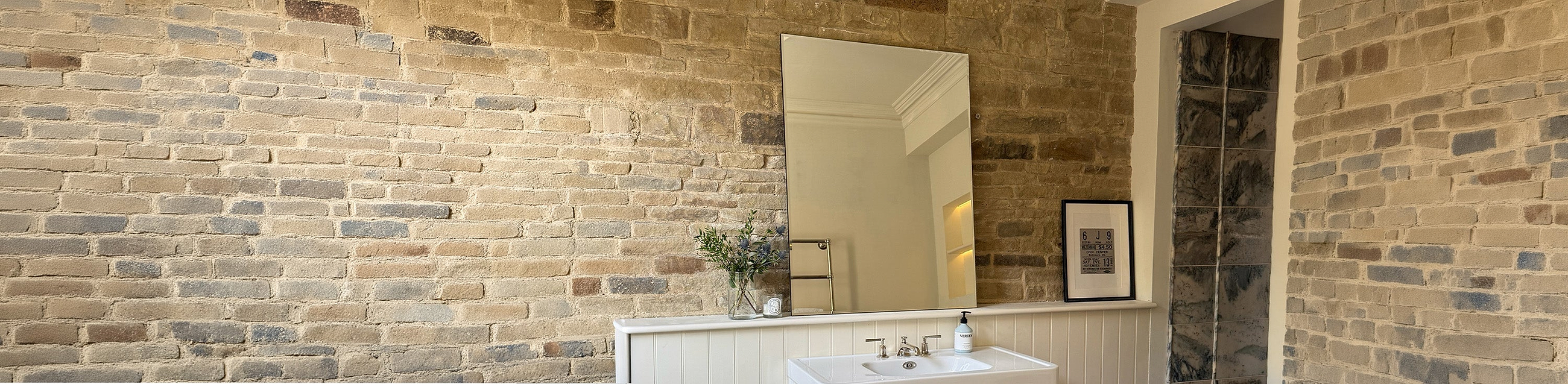 Irregular wall mirror in a bathroom setting