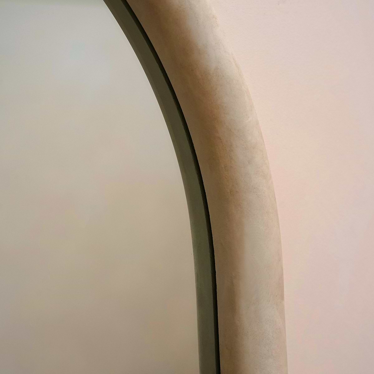 Closeup of Full length arched concrete mirror