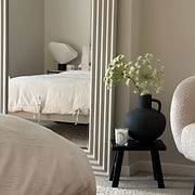 Full length ribbed concrete mirror leaning against wall