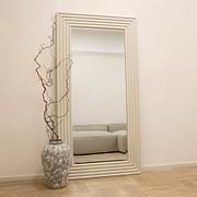 Full length ribbed concrete mirror leaning against wall