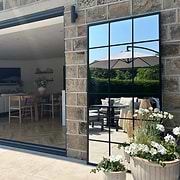 Full length large black metal window mirror as garden mirror