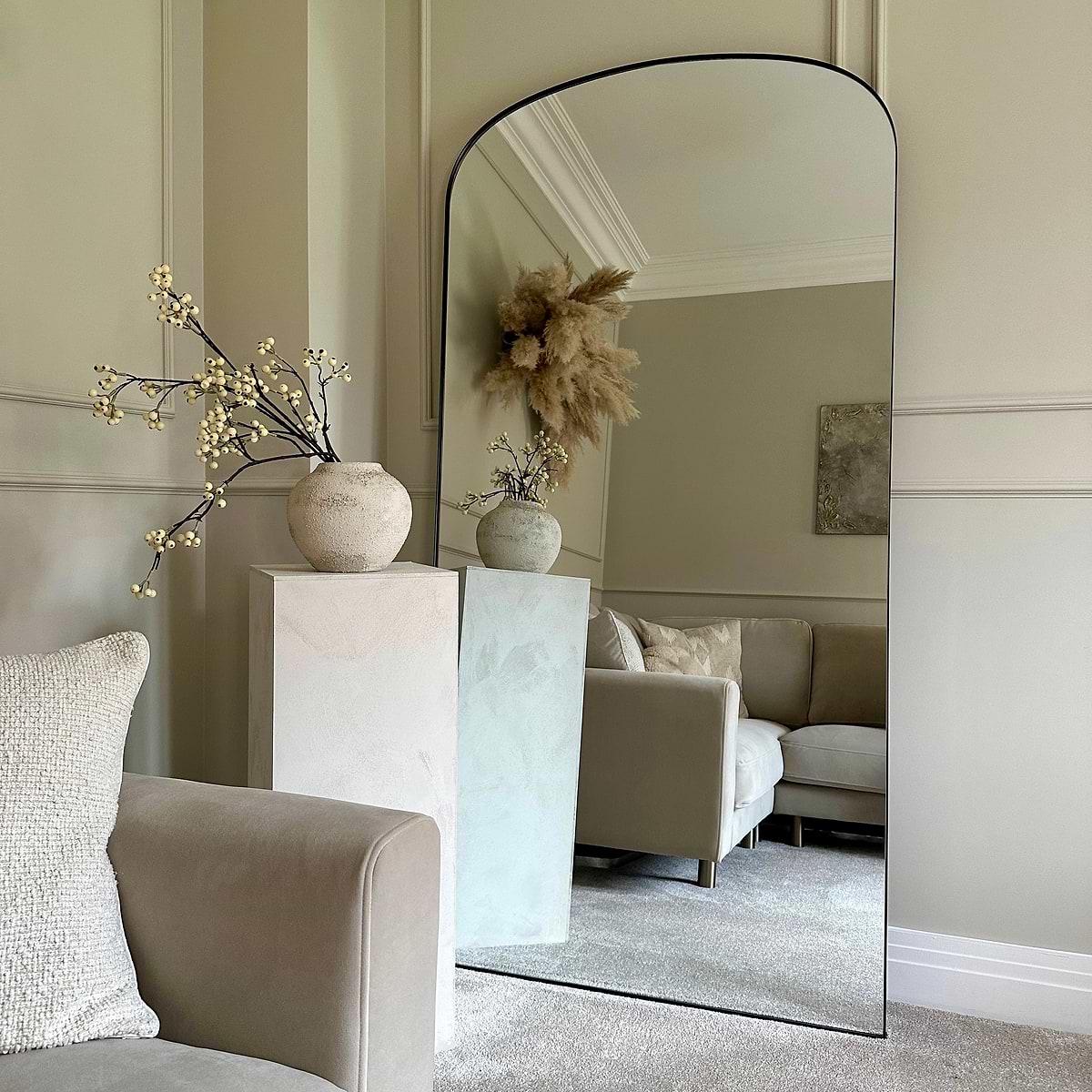 Full length black large metal mirror leaning against wall