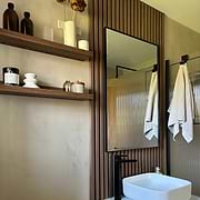 Black Rectangular Metal Wall Mirror by bathroom shelves