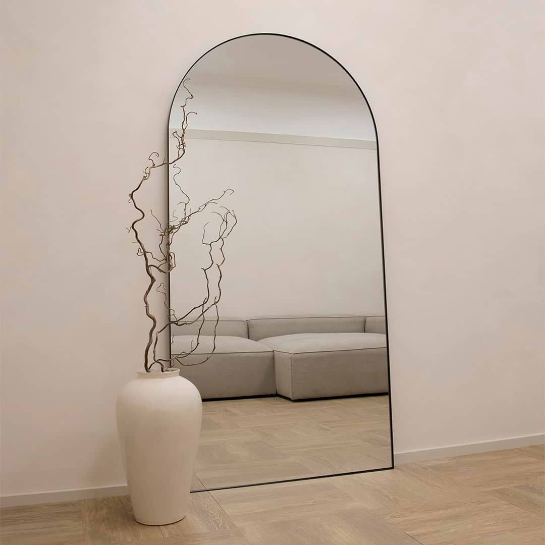 Full Length Black Arched Large Metal Mirror beside vase