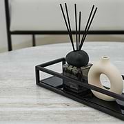 Detail shot of Black modern large rectangle tinted mirrored decorative tray on Artemis travertine table