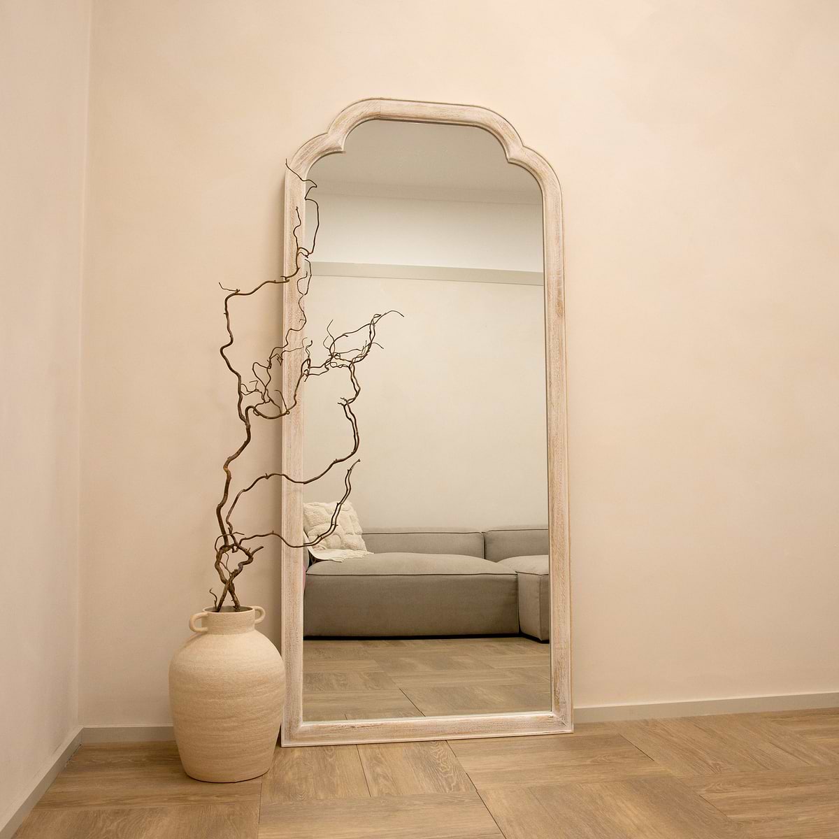 Full Length White Washed Wood Arched Mirror beside ceramic vase