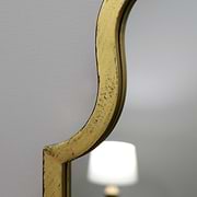 Closeup Gold industrial arched full length metal mirror