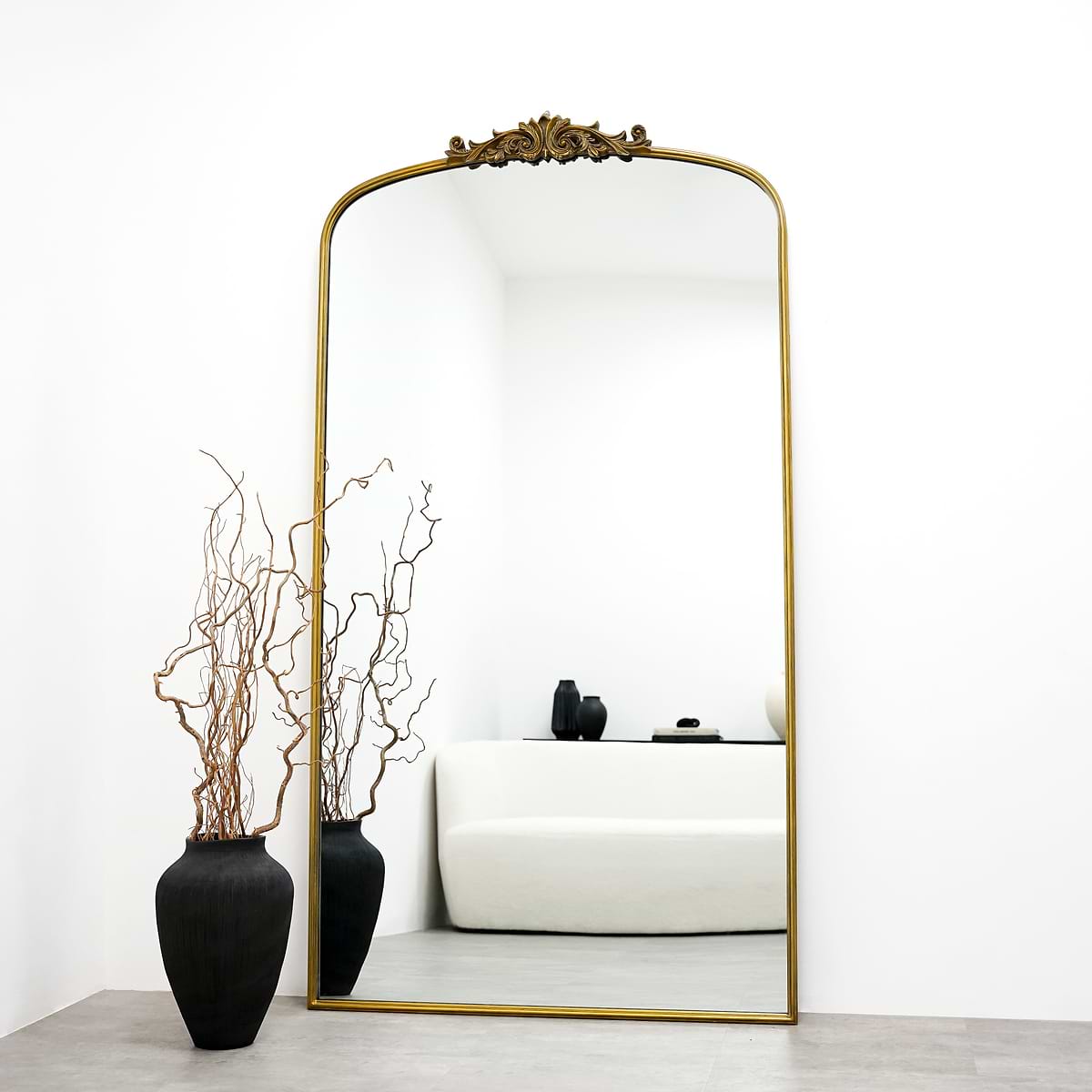 Extra large gold vintage arched metal mirror leaning against wall