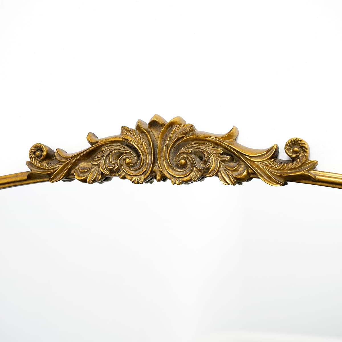 Closeup of extra large gold ornate arched metal mirror
