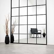 Full length XXL black industrial metal window mirror beside vase