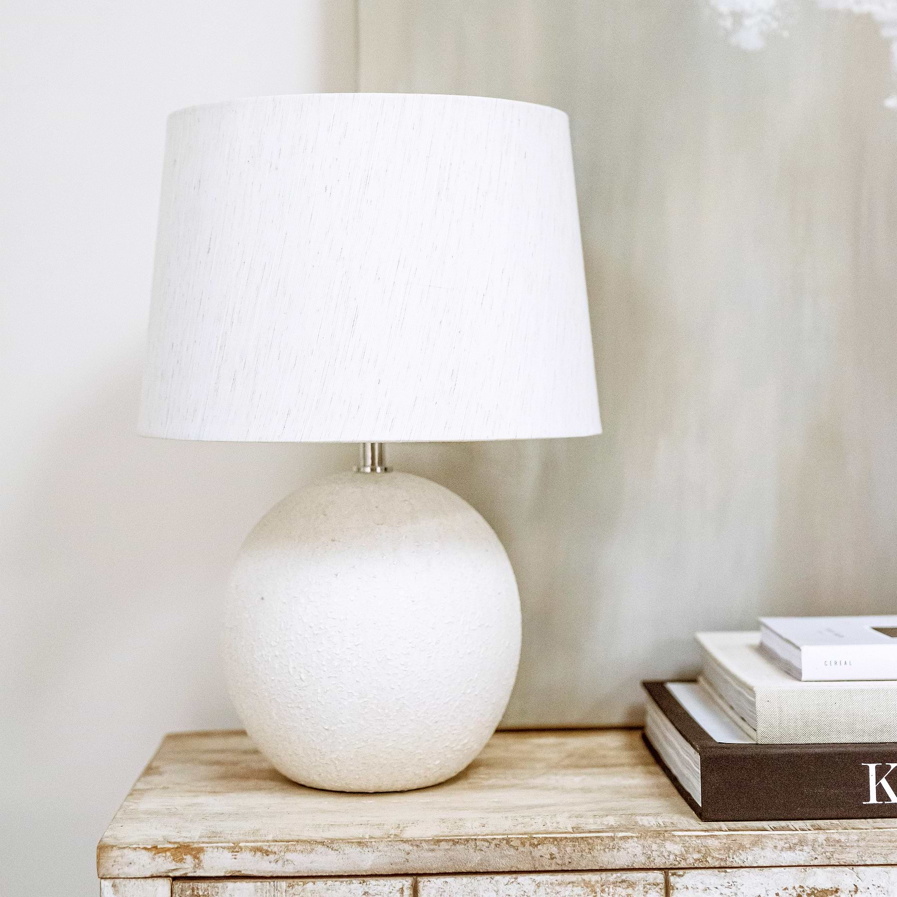 Stone ceramic drum shade table lamp on console table - off