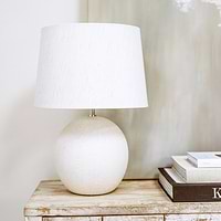 Stone ceramic drum shade table lamp on console table - off