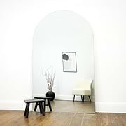 Extra large frameless arched full length mirror by stool