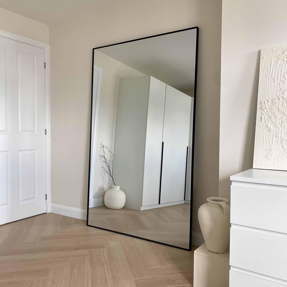 Full Length Black Extra Large Metal Mirror beside plinths