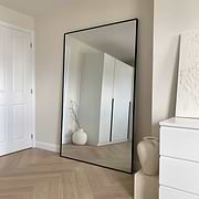 Full Length Black Extra Large Metal Mirror beside plinths
