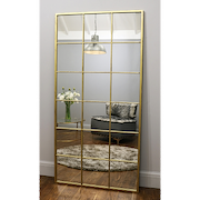 Full length large gold industrial metal window mirror leaning against wall