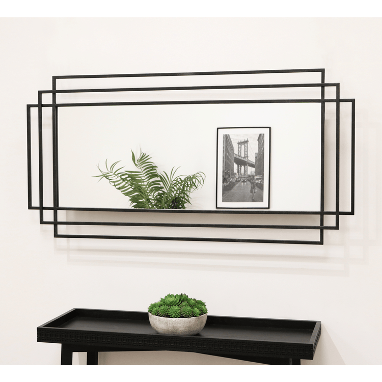 Large black rectangular metal mirror displayed on wall