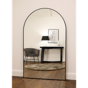 Black Full Length Arched Metal Mirror reflecting lounge