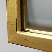 Detail shot of Large gold industrial metal window mirror corner