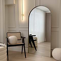 Full length arched gold large metal mirror leaning against wall