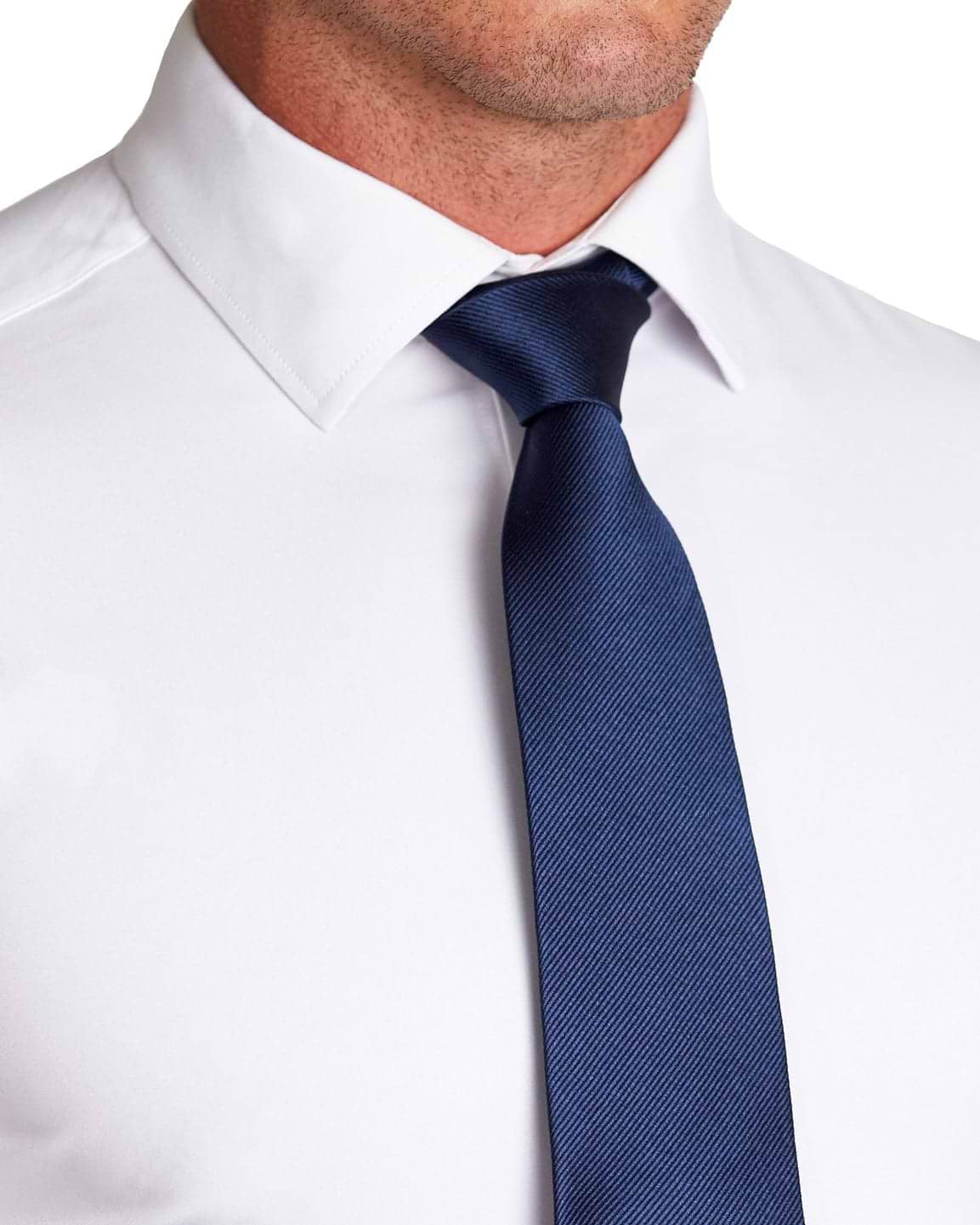 Man wearing a white dress shirt and a blue tie on a white background