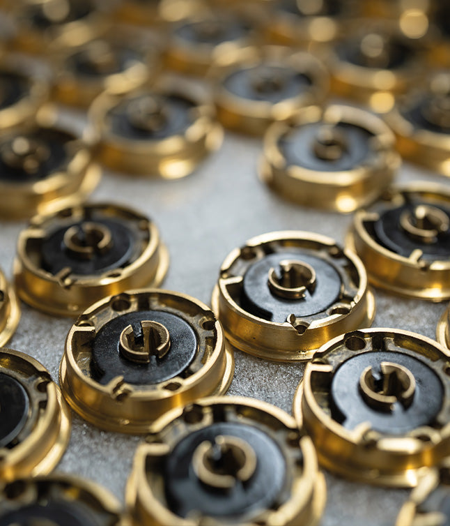 Batch of sprung door handle internal mechanisms.