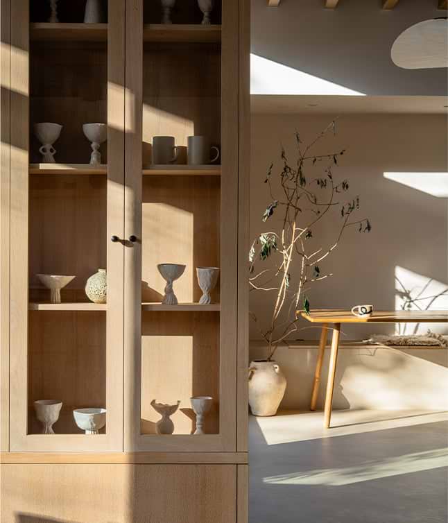 Kitchen storage cupboard with glass panes, revealing the contents inside