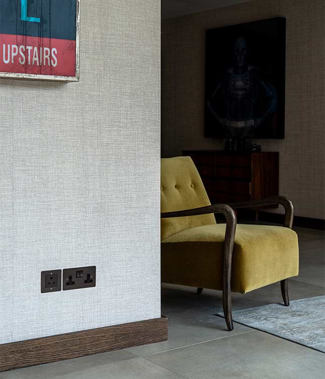 A corner of a stylish living room featuring a vintage 