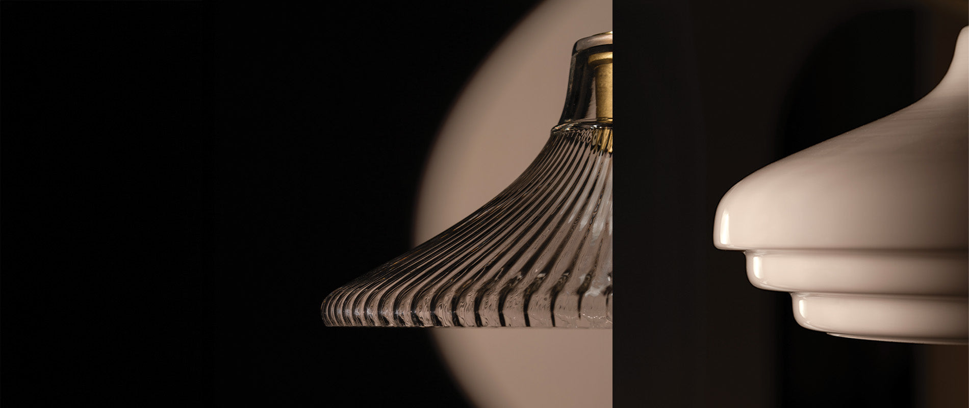 Two lamp shades are displayed side by side: one glass with vertical ridges and the other smooth, white ceramic, both against a dark background.