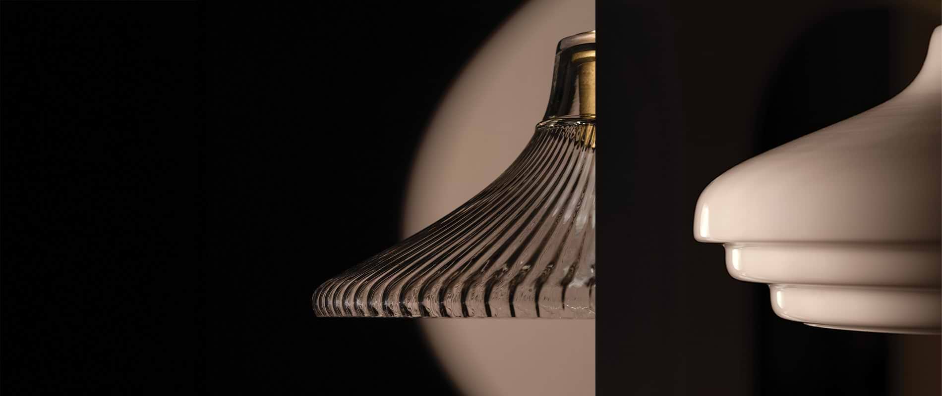 Two lamp shades are displayed side by side: one glass with vertical ridges and the other smooth, white ceramic, both against a dark background.