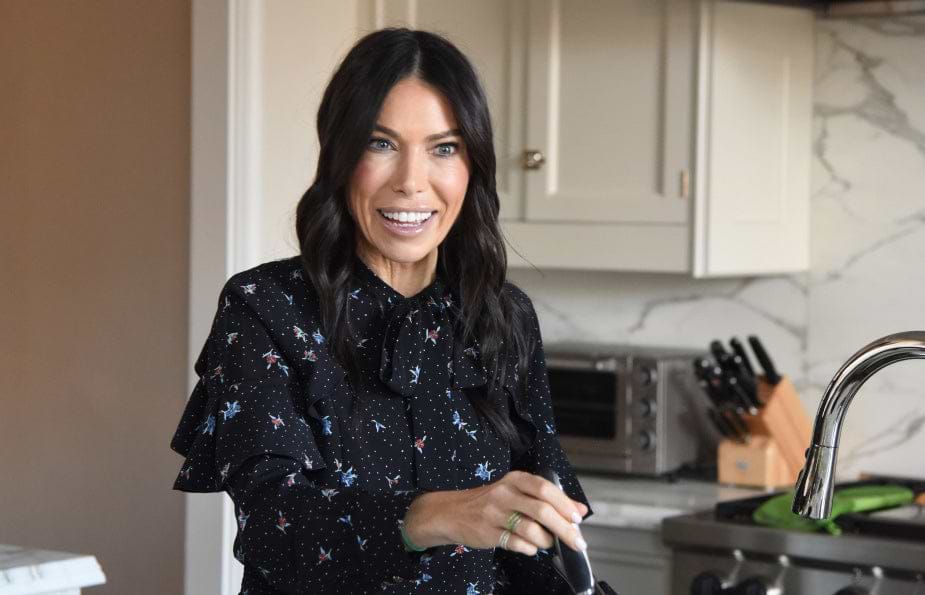 a woman smiling in a kitchen