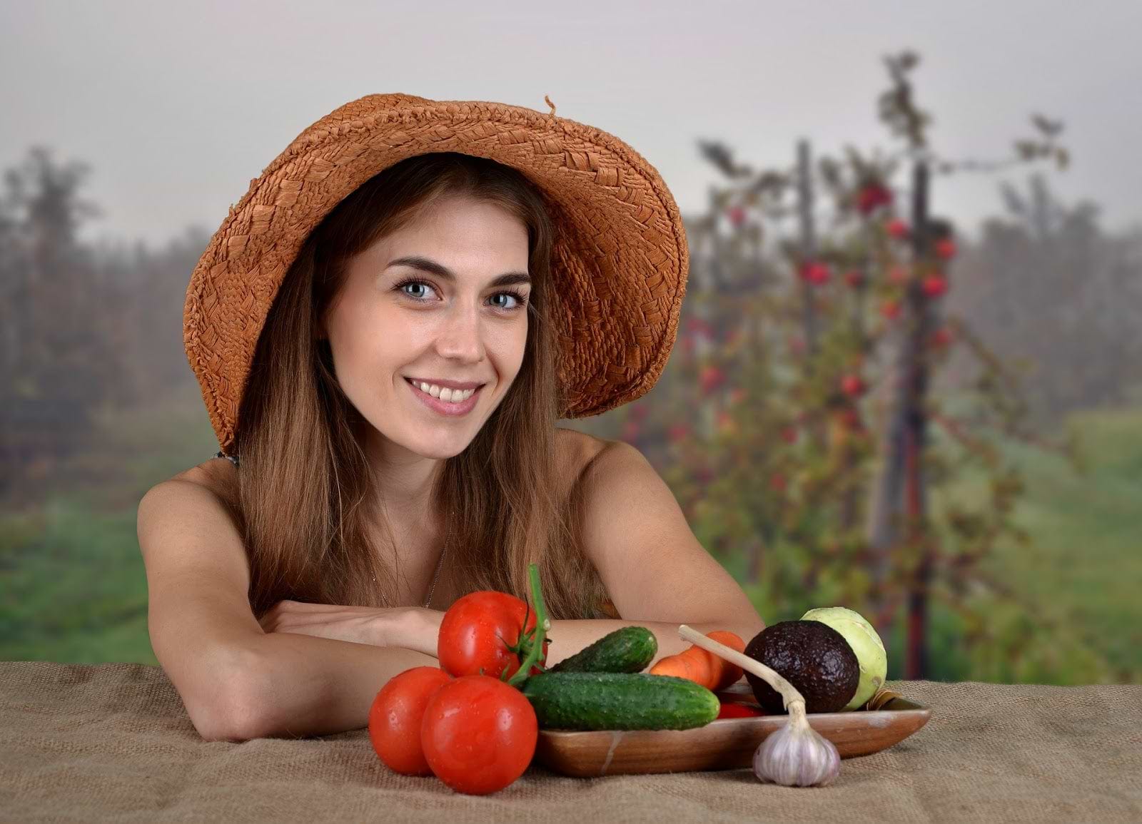 How to balance hormones: Girl in a farmer's hat with vegetables