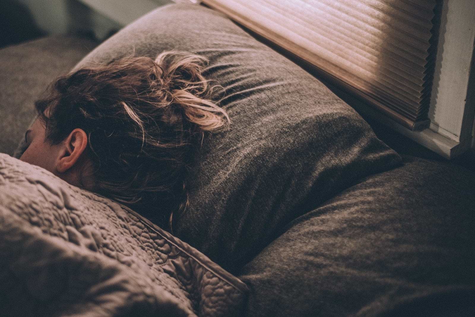 Gut dysbiosis: A woman asleep in bed