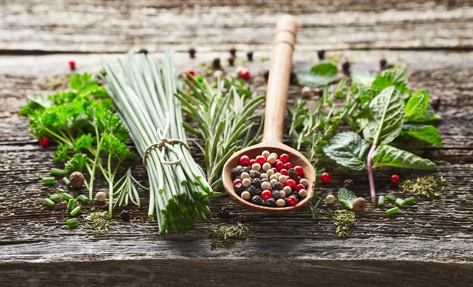 Adaptogenic herbs: Wooden spoon with corn peppers and spices on table