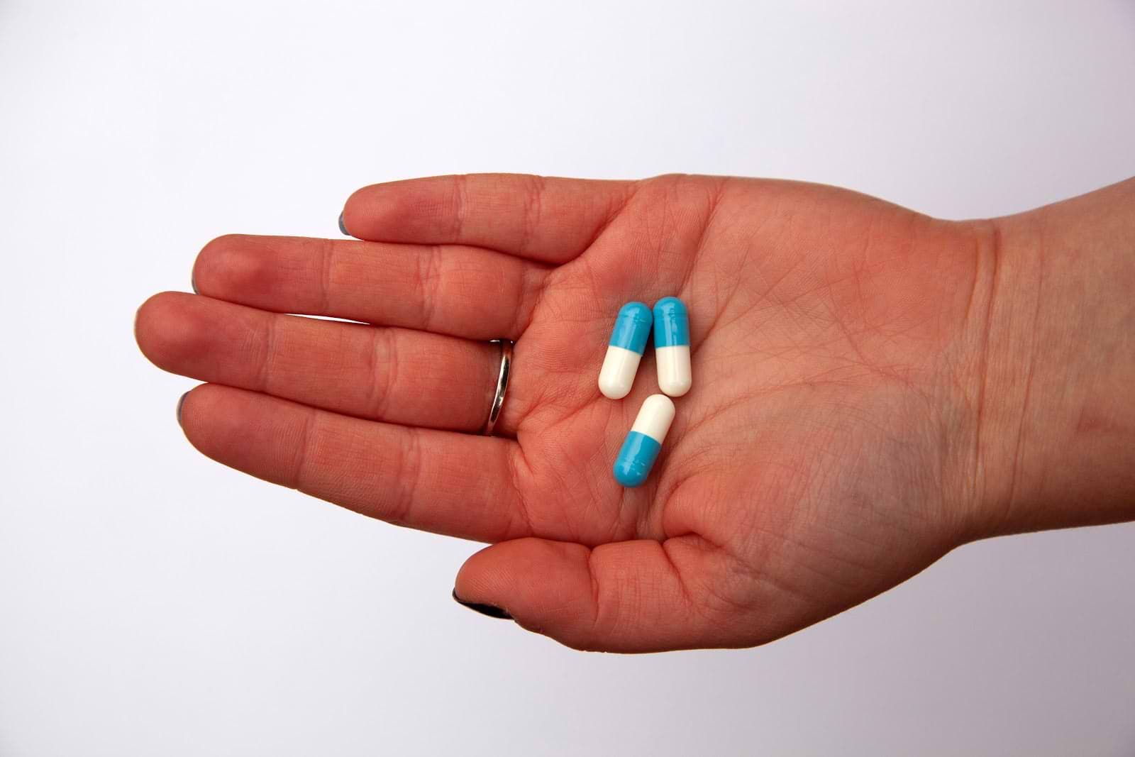 Probiotics for constipation: a hand holds pills