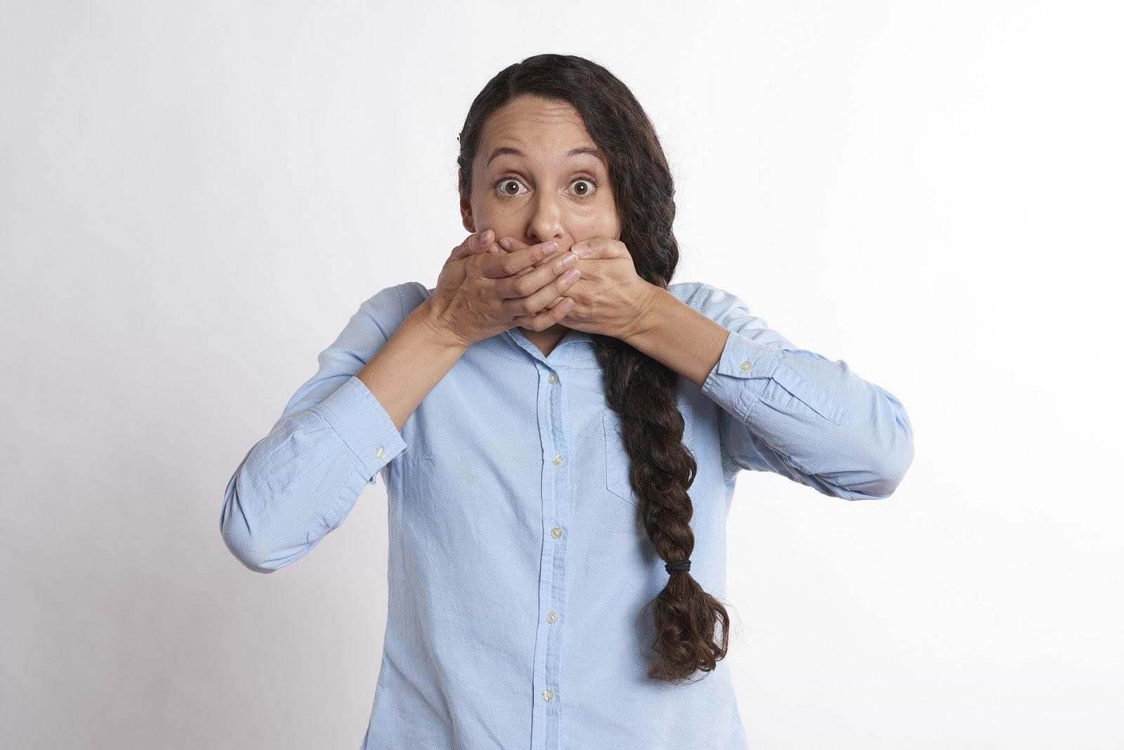 Gut dysbiosis: A woman covers her mouth with her hands