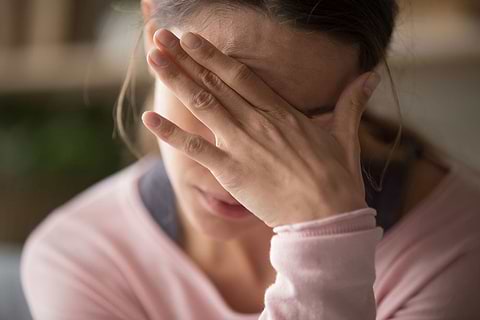 woman holding her head