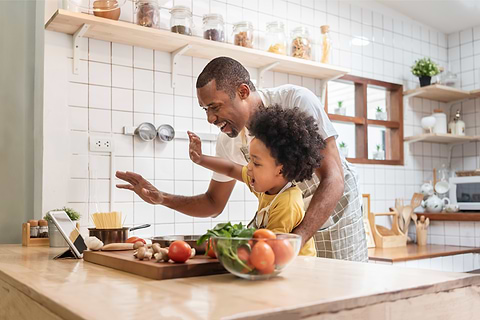 Girl and Dad Cooking Together in the kitchen