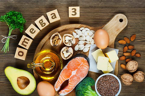 omega 3 spelled in scrabble blocks surrounded by healthy foods