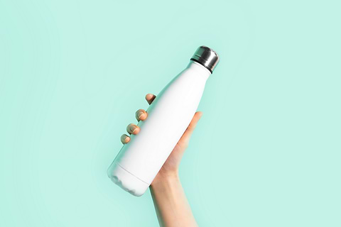 hand holding a white water bottle 