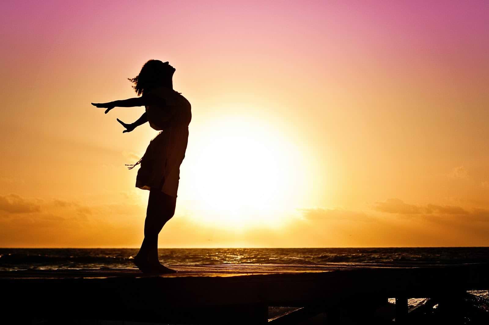 How to balance hormones: silhouette of a woman at sunset