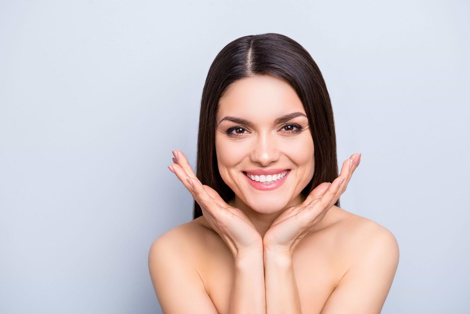 Woman smiling because she's eaten foods with collagen