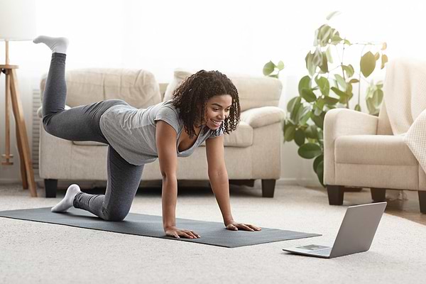 Woman exercising at home to support her gut cleanse