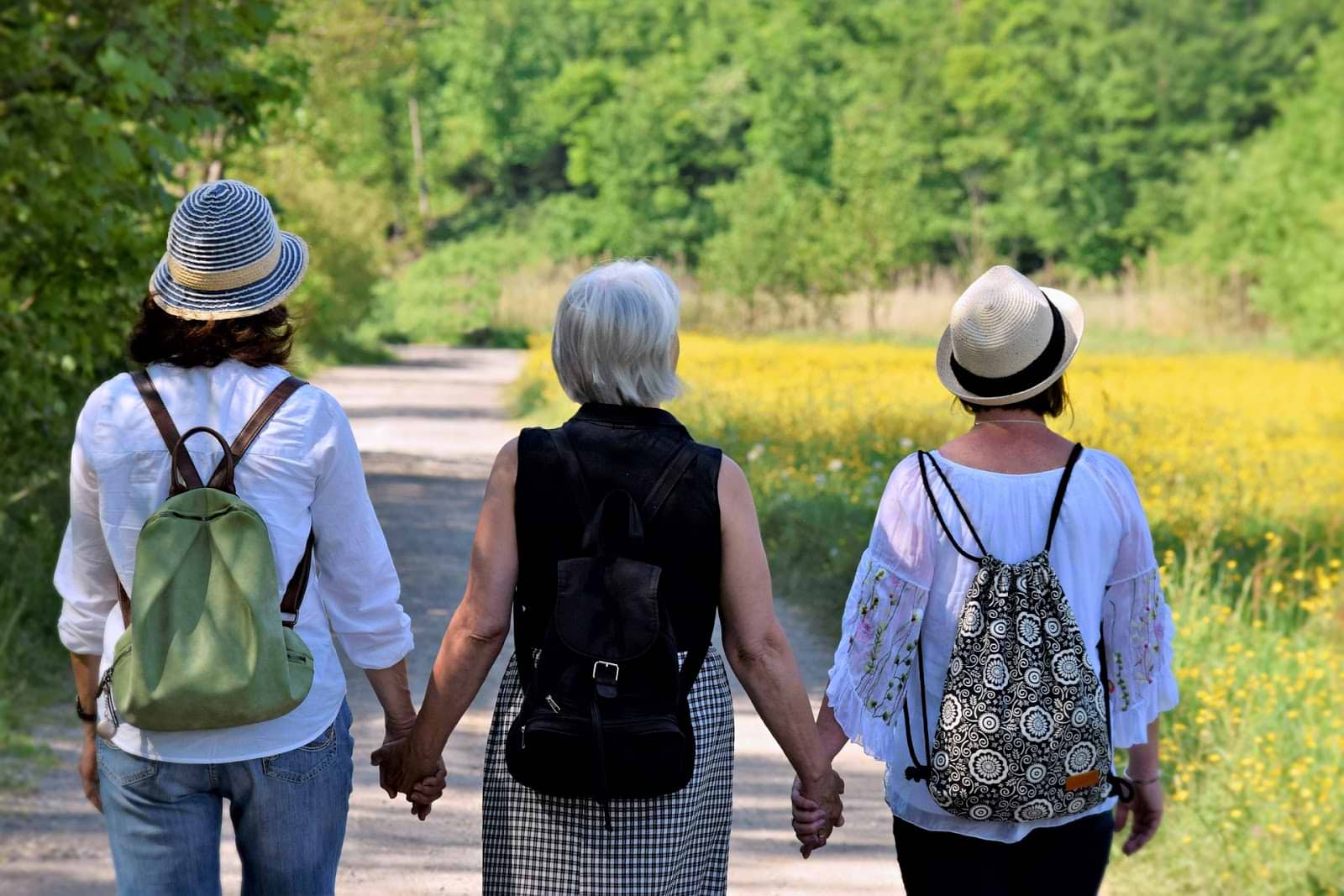 Three older women holding hands
