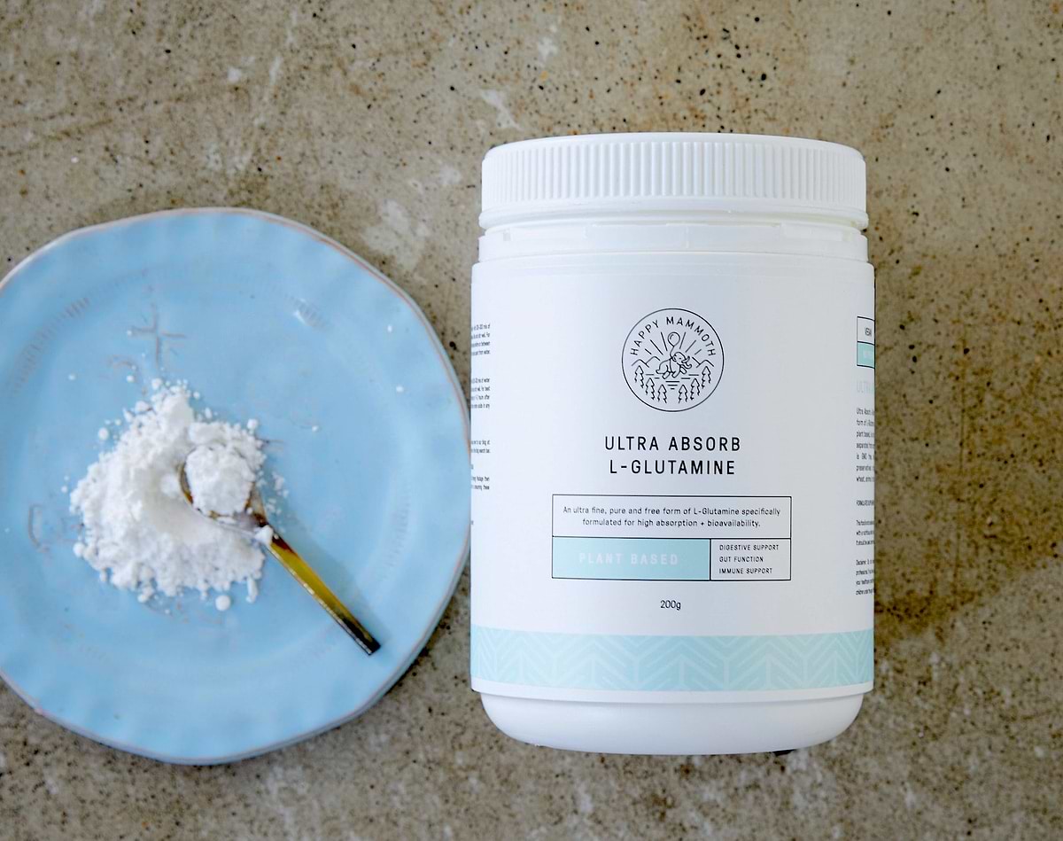 Happy mammoth l-glutamine with a spoon of powder on a plate