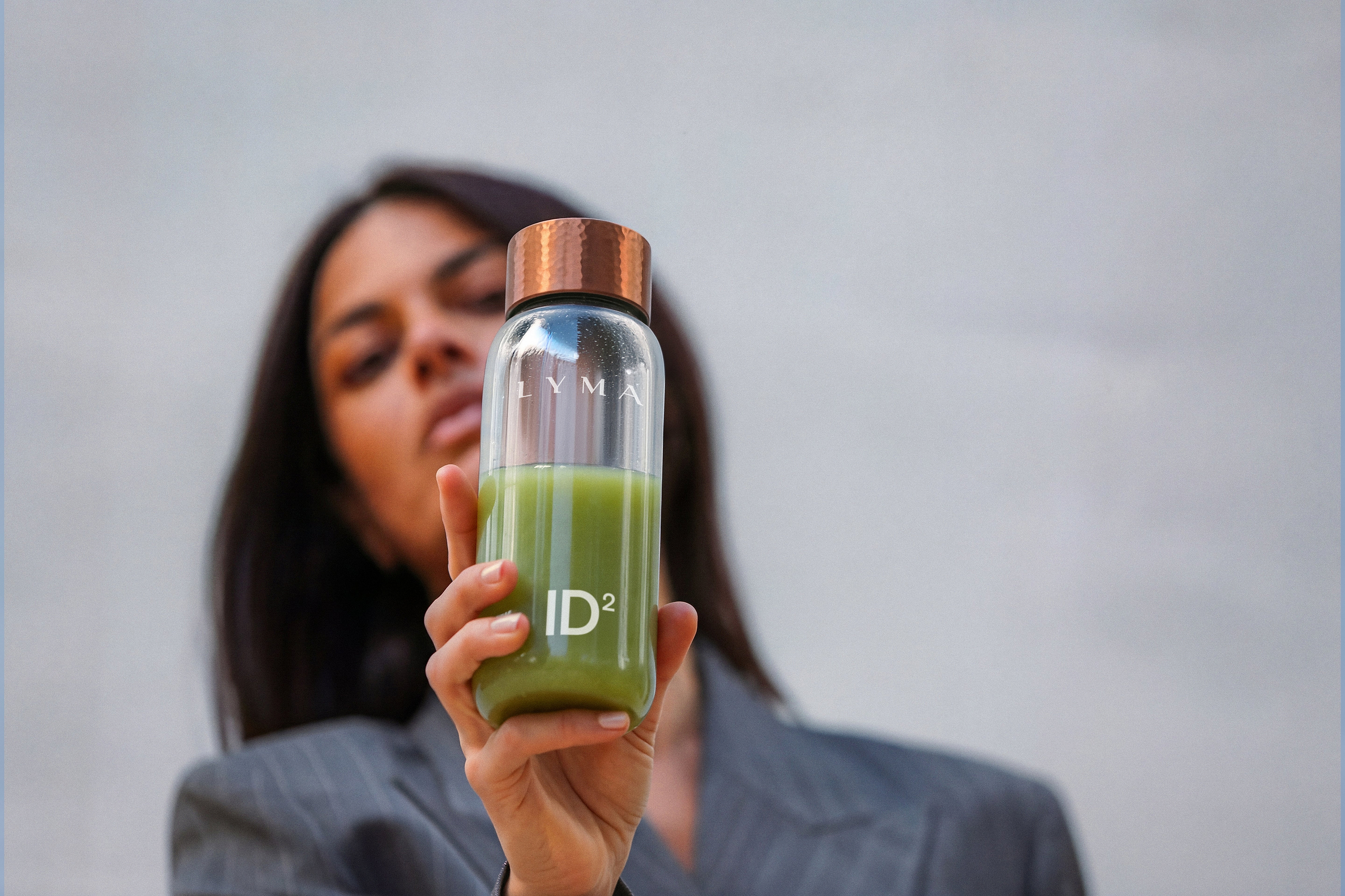 Woman holding LYMA ID2 bottle copper
