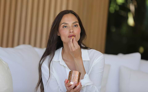 Lady holding LYMA Supplement pill