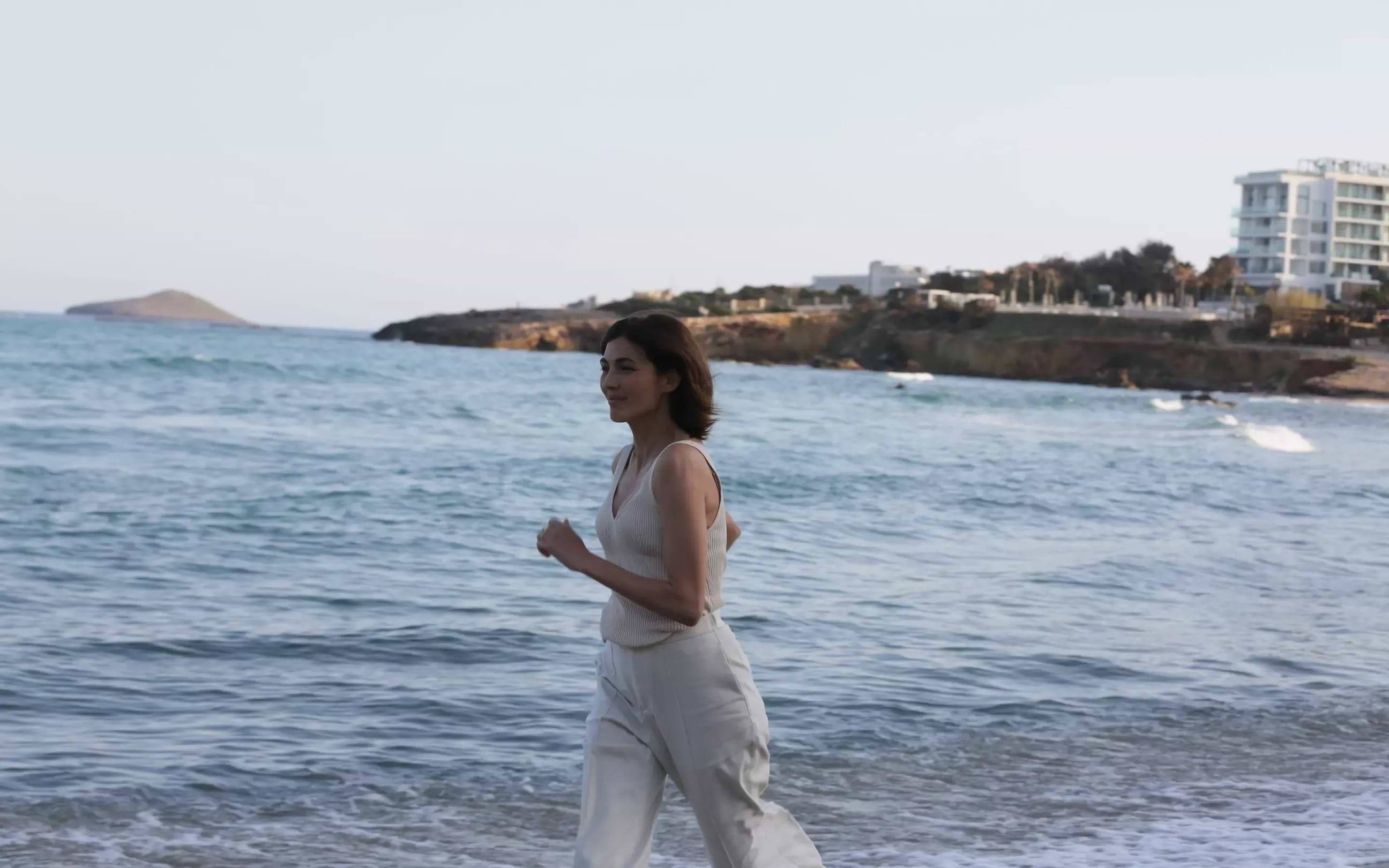 perimenopausal lady walking in sand