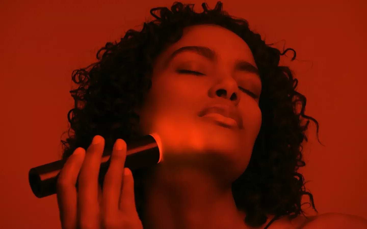 Woman using LYMA Laser red filter for skin rejuvenation